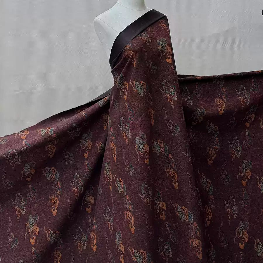 A mannequin wearing a large, burgundy-colored dress with a floral pattern.