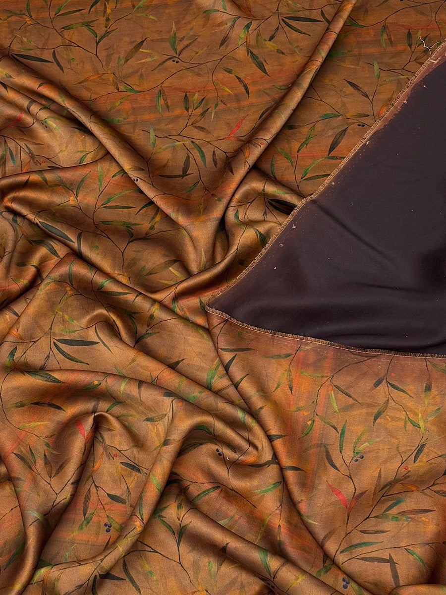 a close-up view of a fabric with a leafy pattern in shades of brown and green. The fabric appears to be crumpled and wrinkled, giving it a textured and organic appearance.