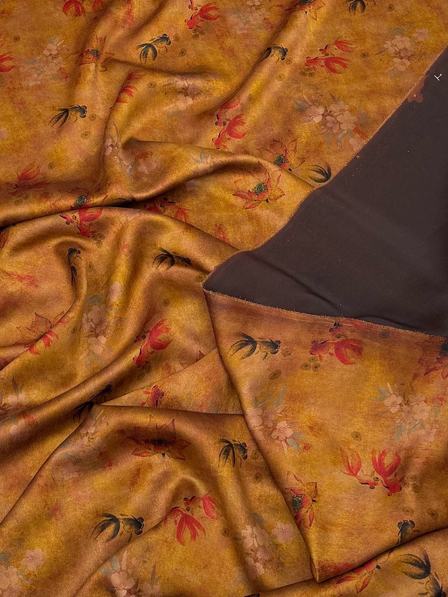 a close-up view of a fabric with a floral pattern in shades of brown and orange. The fabric appears to be made of silk or a similar material, and it has a crinkled texture. The pattern consists of various flowers and leaves in different sizes and colors, creating a visually appealing and intricate design.