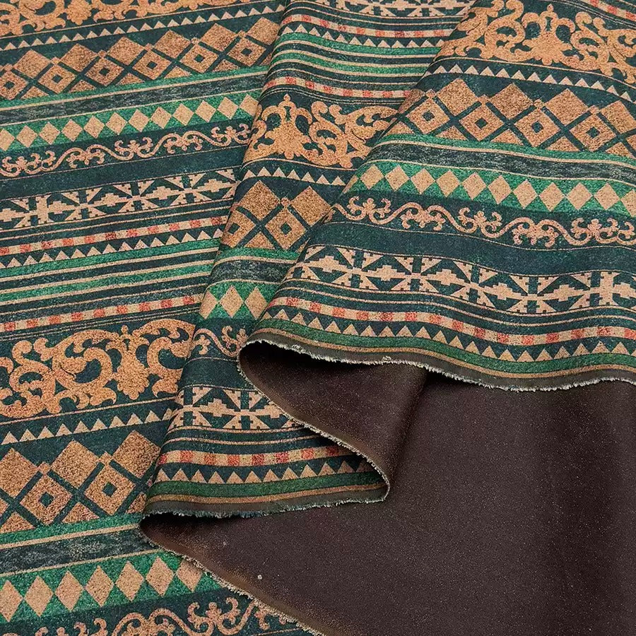 a close-up view of a fabric with a repeating pattern of geometric shapes in shades of green, brown, and orange. The pattern is intricate and detailed, with a mix of horizontal and vertical lines creating a visually striking design. The fabric appears to be made of a soft, plush material, suggesting it could be used for clothing or home decor.