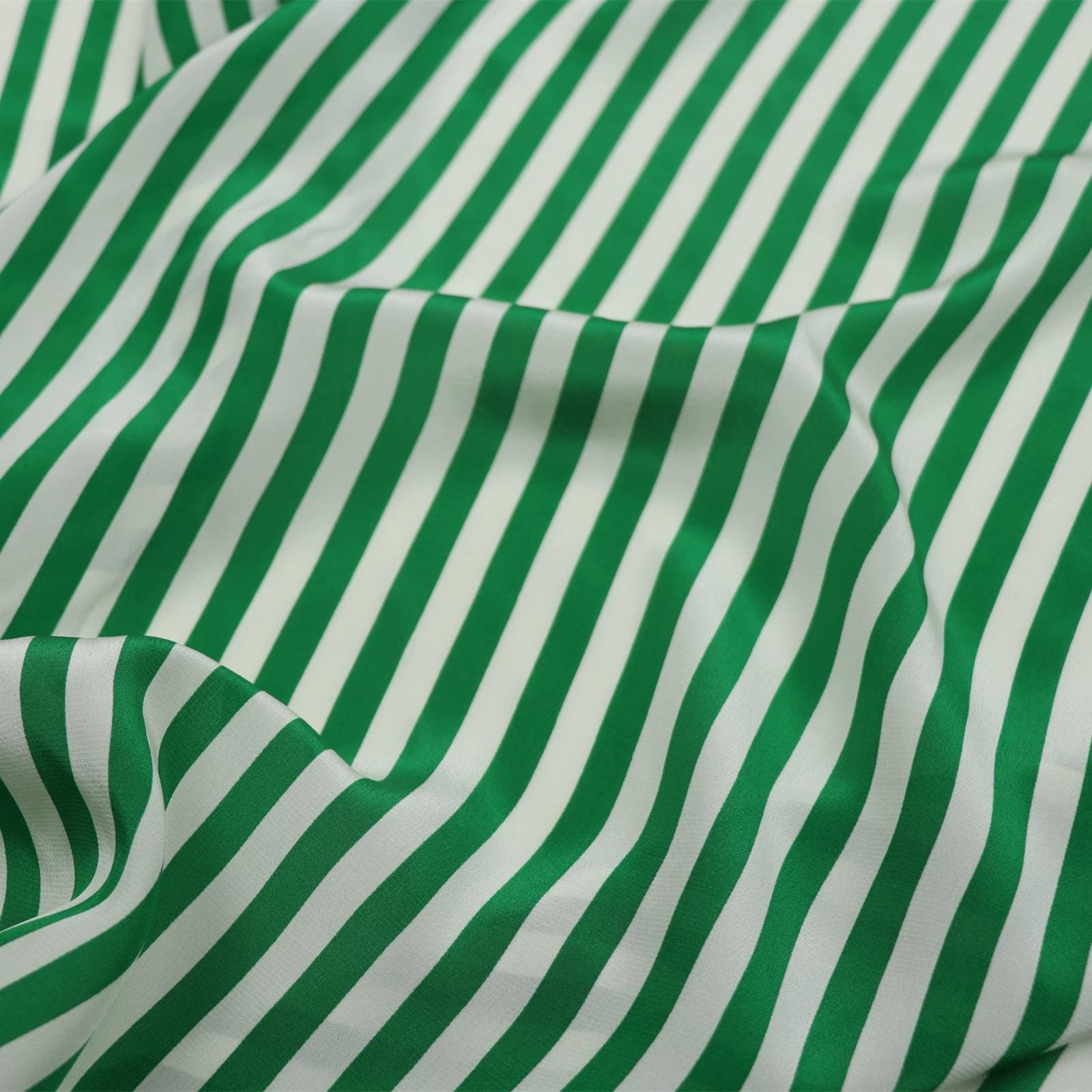 a close-up view of a fabric with green and white striped patterns.