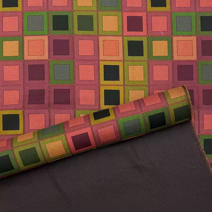 a vibrant, colorful pattern of squares and rectangles in various shades of green, orange, and pink. The pattern is displayed on a dark background, creating a striking contrast.