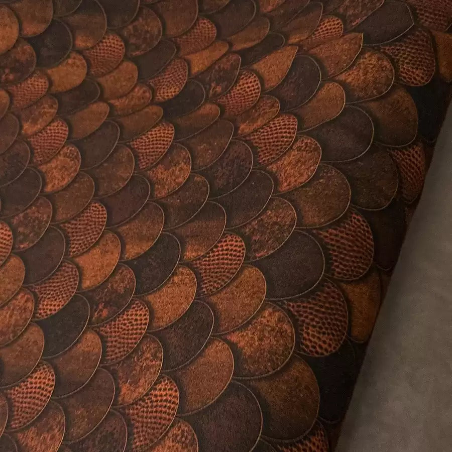 a close-up view of a textured surface with a repeating pattern of overlapping circles in shades of brown and orange.