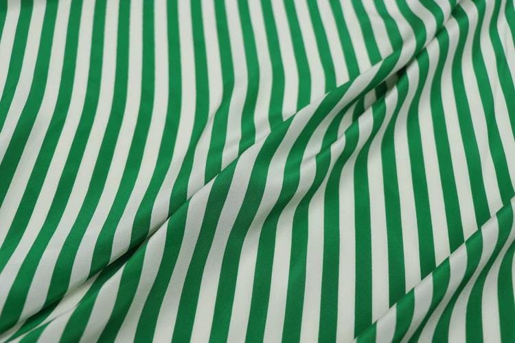 a close-up view of a fabric with green and white striped patterns.