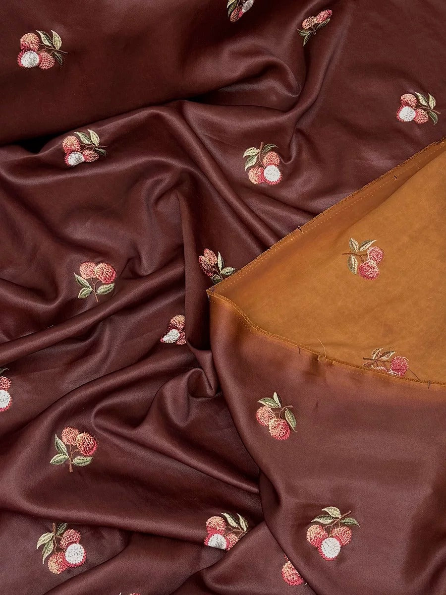 a close-up view of a fabric with a repeating pattern of small red and white flowers or berries, creating a visually appealing and intricate design.