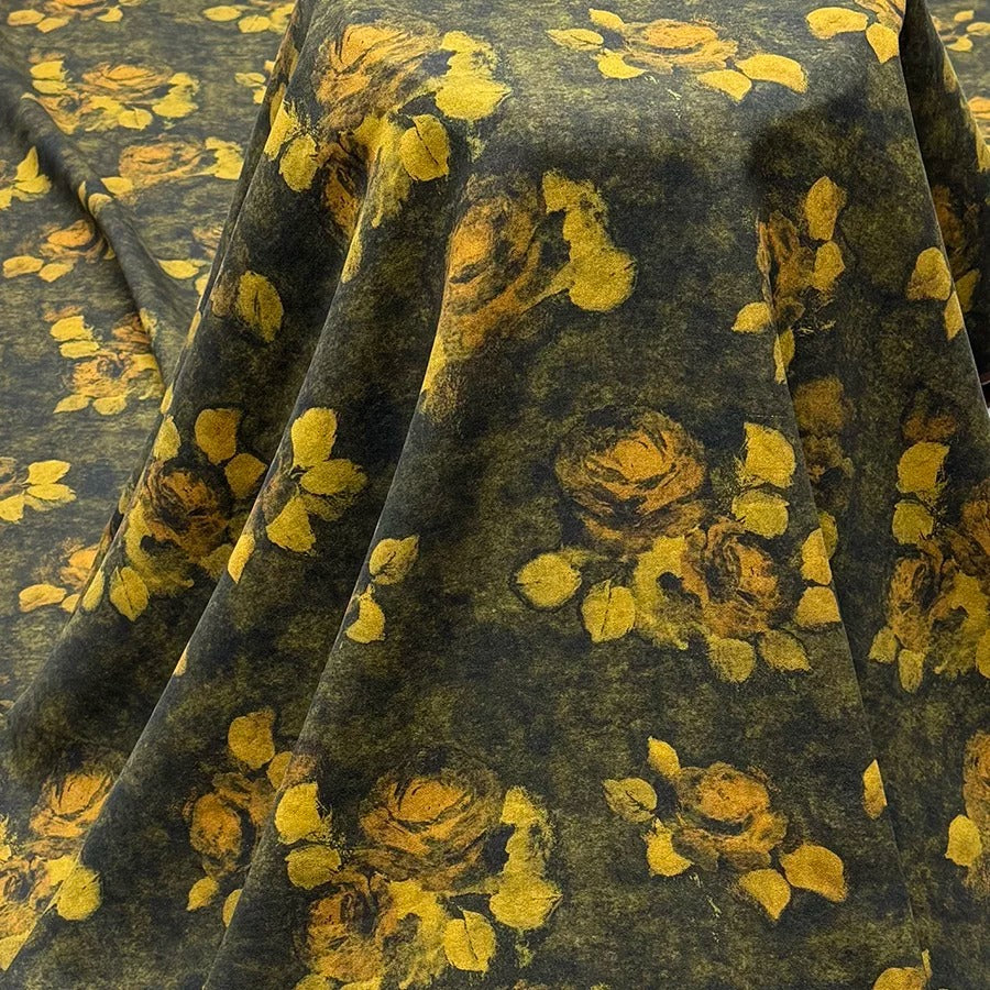a close-up view of a fabric with a floral pattern of yellow flowers against a dark green background.