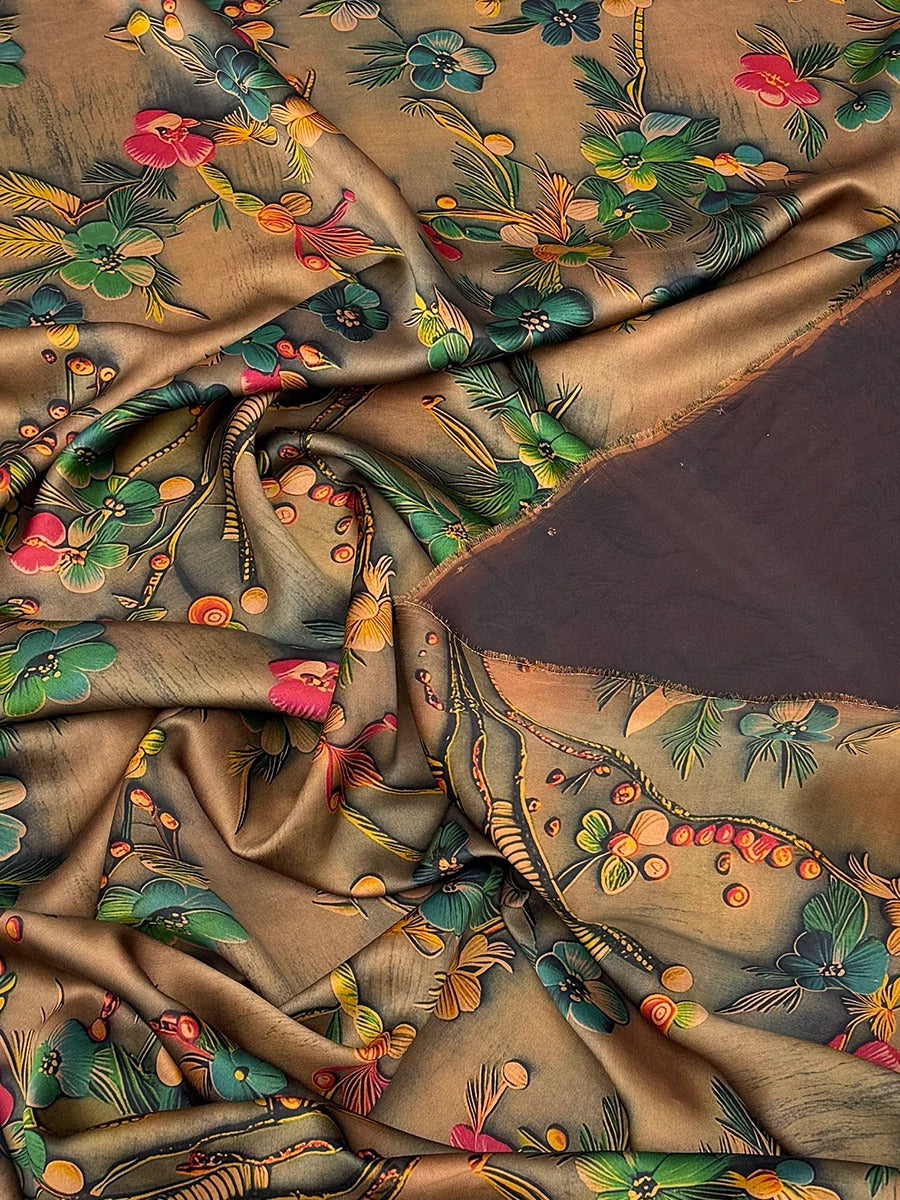 The image is a close-up view of a fabric with a vibrant, colorful floral pattern. The fabric appears to be made of silk or a similar material, and the pattern features a variety of flowers and leaves in shades of green, yellow, and red. The fabric is crumpled and wrinkled, giving it a textured and dynamic appearance.