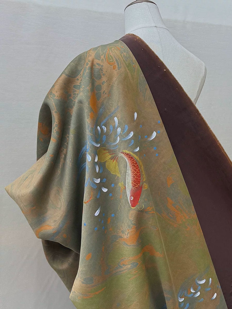 a mannequin wearing a colorful, patterned fabric with a fish design.