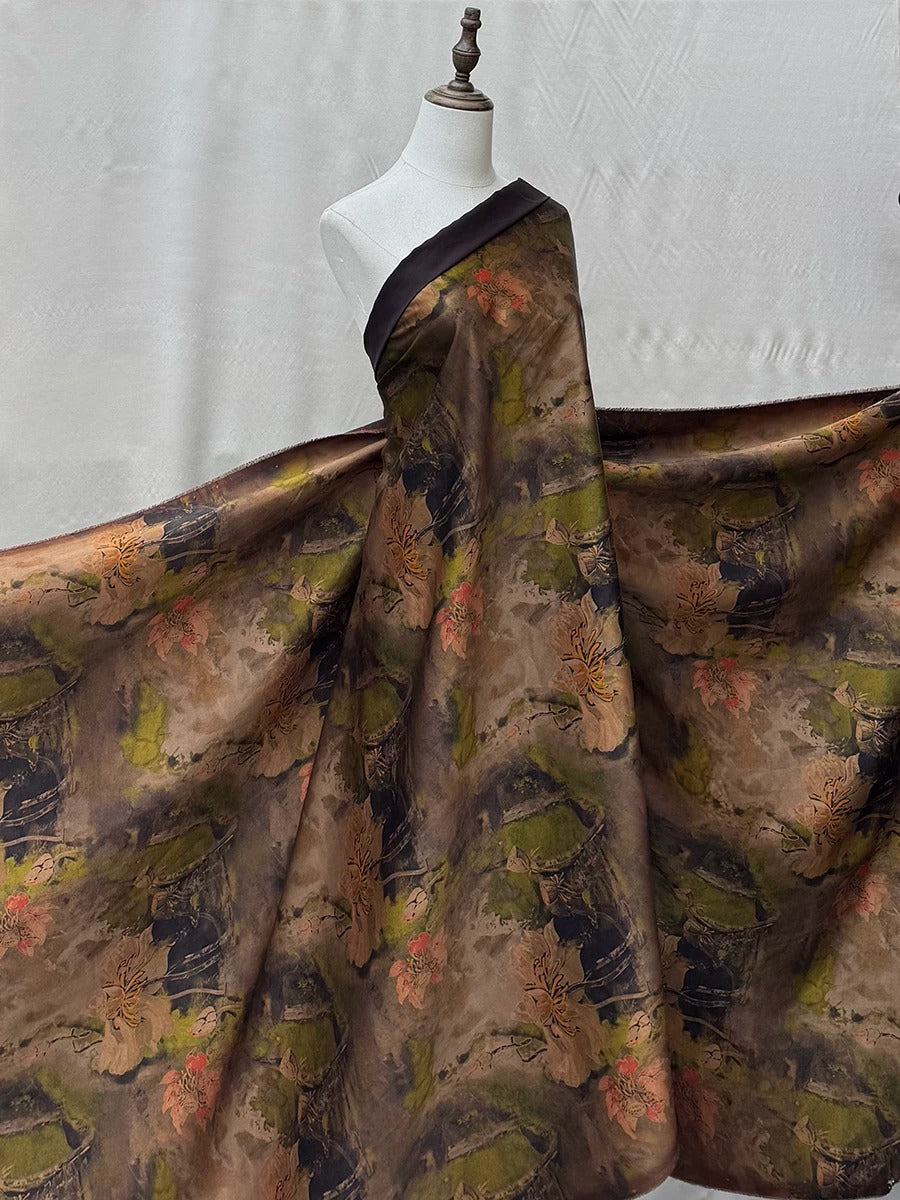 A mannequin wearing a large, flowing dress with a floral print in shades of brown and green.