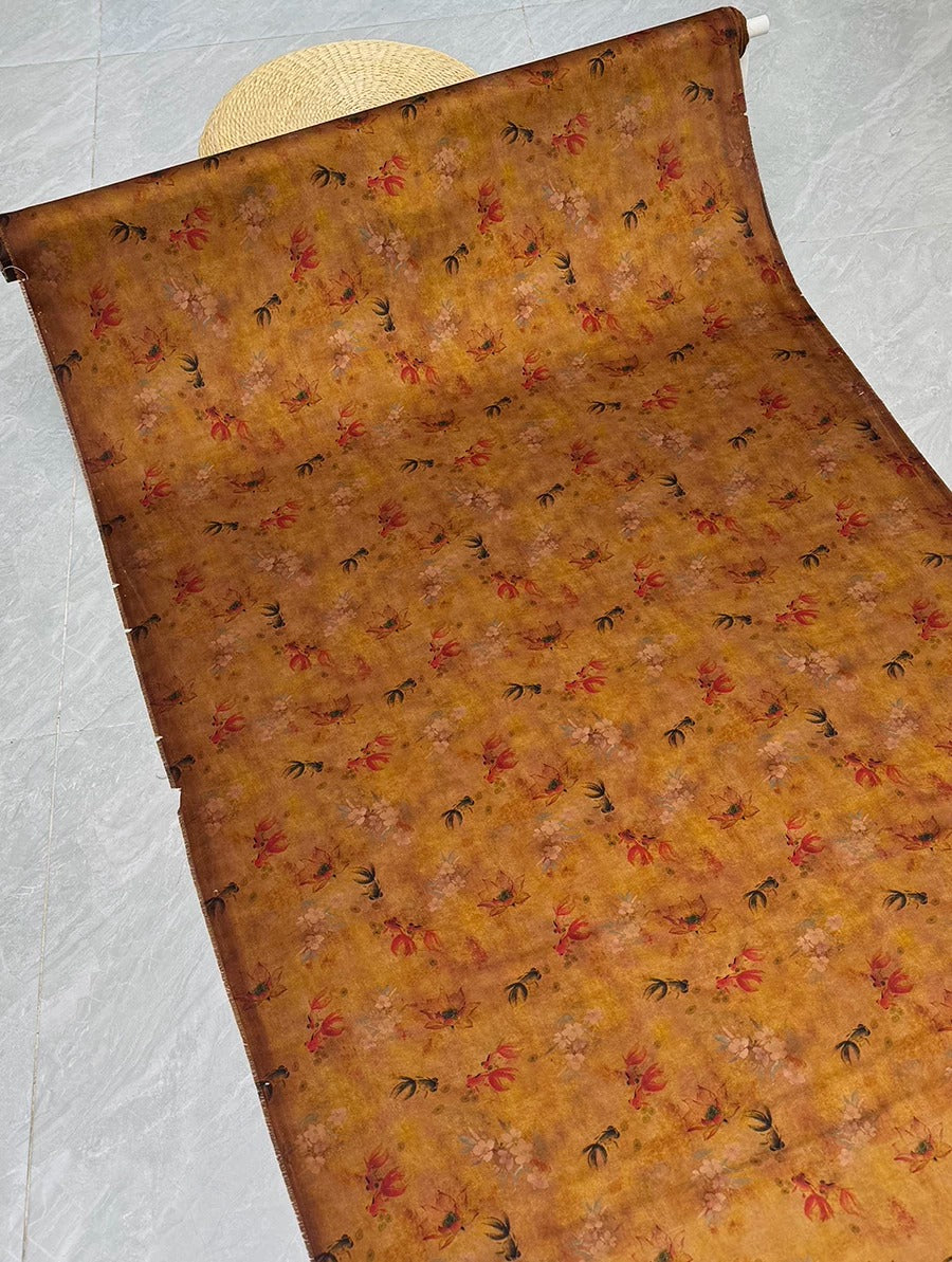 a roll of fabric with a floral pattern, placed on a tiled floor.