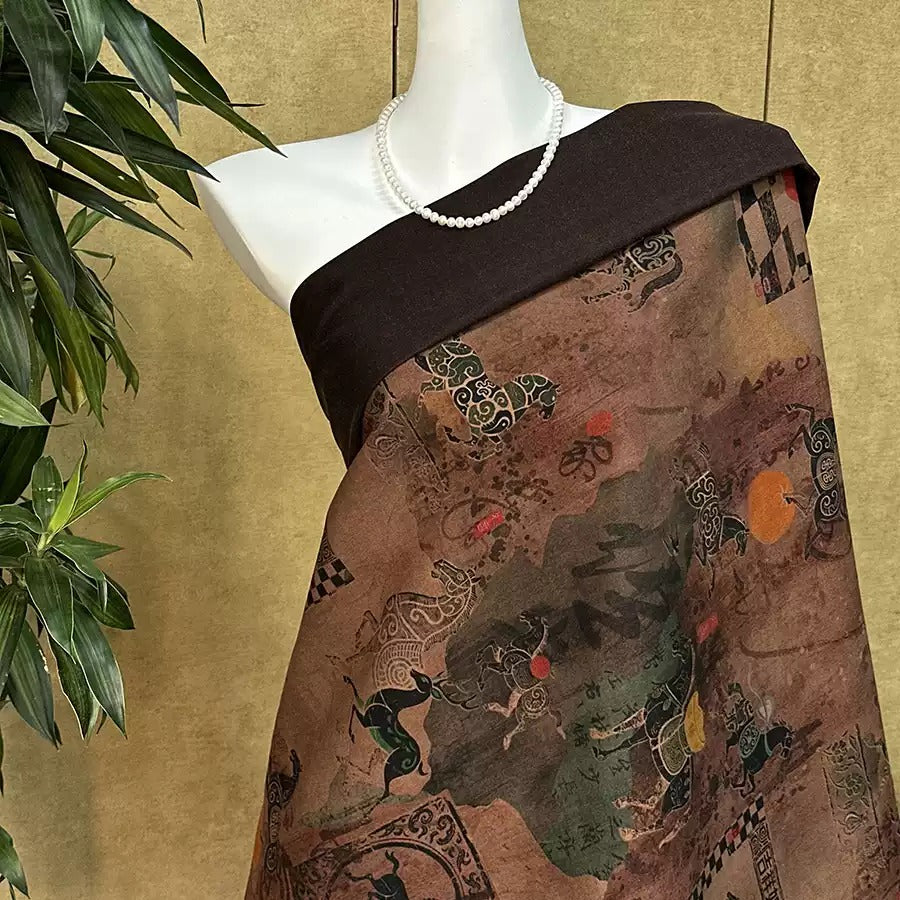 A mannequin wearing a brown dress with a colorful, abstract pattern printed on it, displayed against a beige background with a plant.