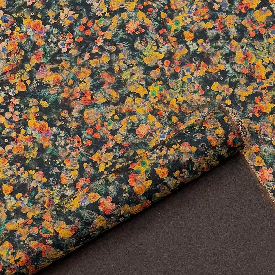 a vibrant, colorful floral pattern with a mix of yellow, orange, and green hues. The pattern appears to be a close-up view of a fabric or paper with a similar design, possibly used for wrapping or decoration.