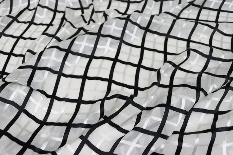 a close-up view of a fabric with a black and white checkered pattern.