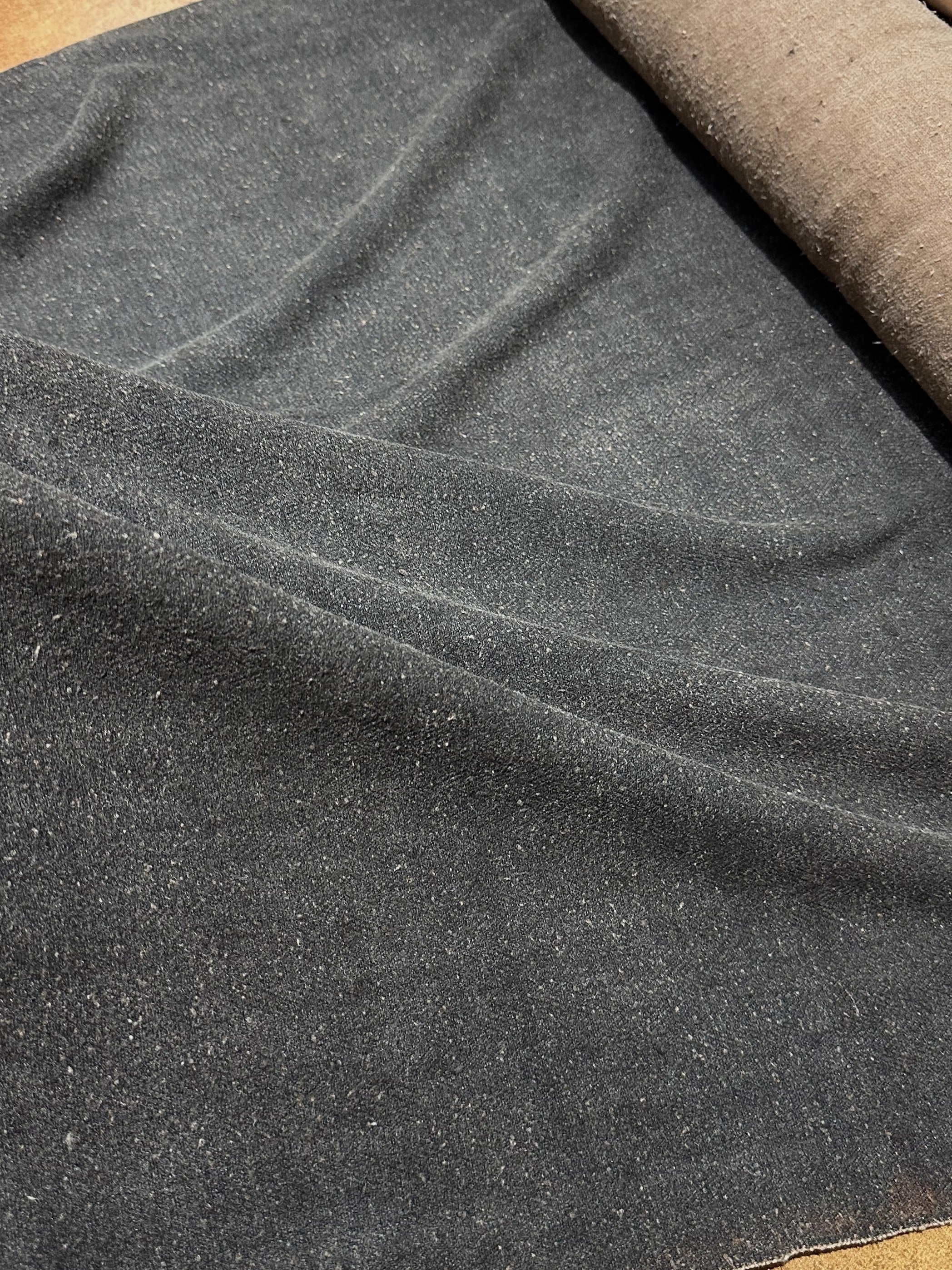 a close up of a piece of cloth on a table#color_black-brown