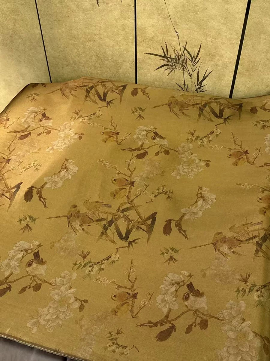 a close-up view of a fabric with a floral pattern, including various types of flowers and leaves. The fabric appears to be a piece of paper or a textile with a decorative design.