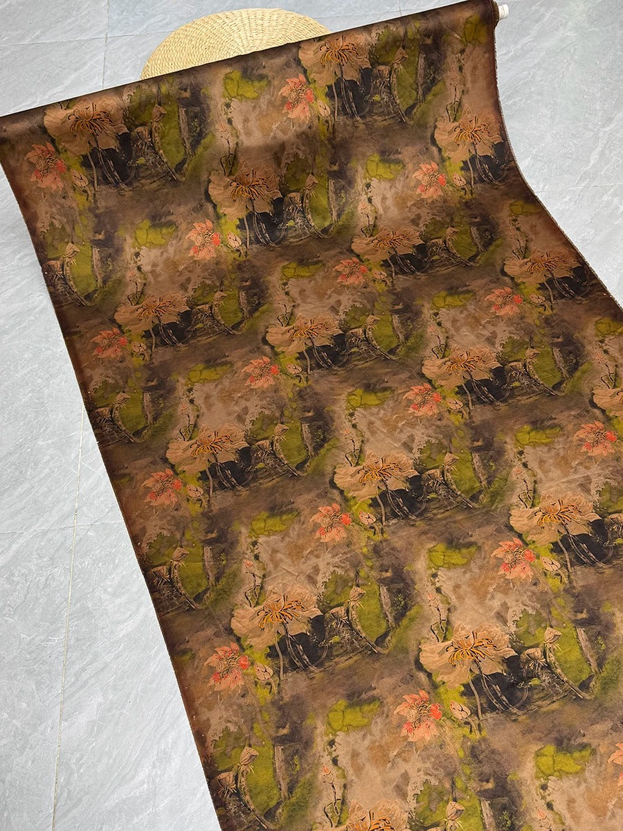 a large roll of fabric with a repeating pattern of green and brown flowers and leaves.