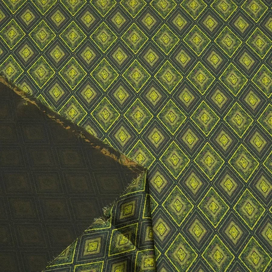 a close-up view of a fabric with a repeating diamond pattern in shades of green and black. The pattern consists of numerous small diamonds arranged in a grid-like fashion, creating a visually striking and intricate design. The fabric appears to be made of a material with a textured surface, adding depth and dimension to the overall appearance.