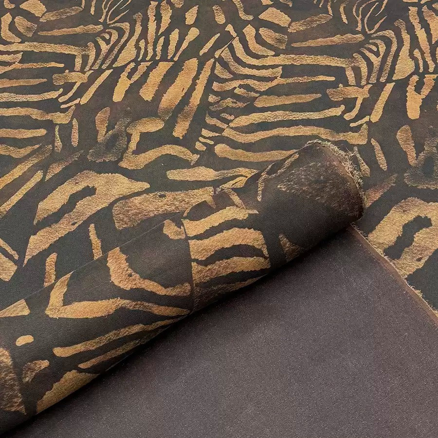 a close-up view of a fabric with a striking zebra-like pattern in shades of brown and black.