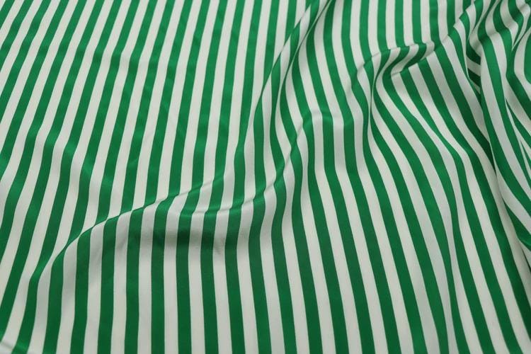 a close-up view of a fabric with green and white striped patterns.