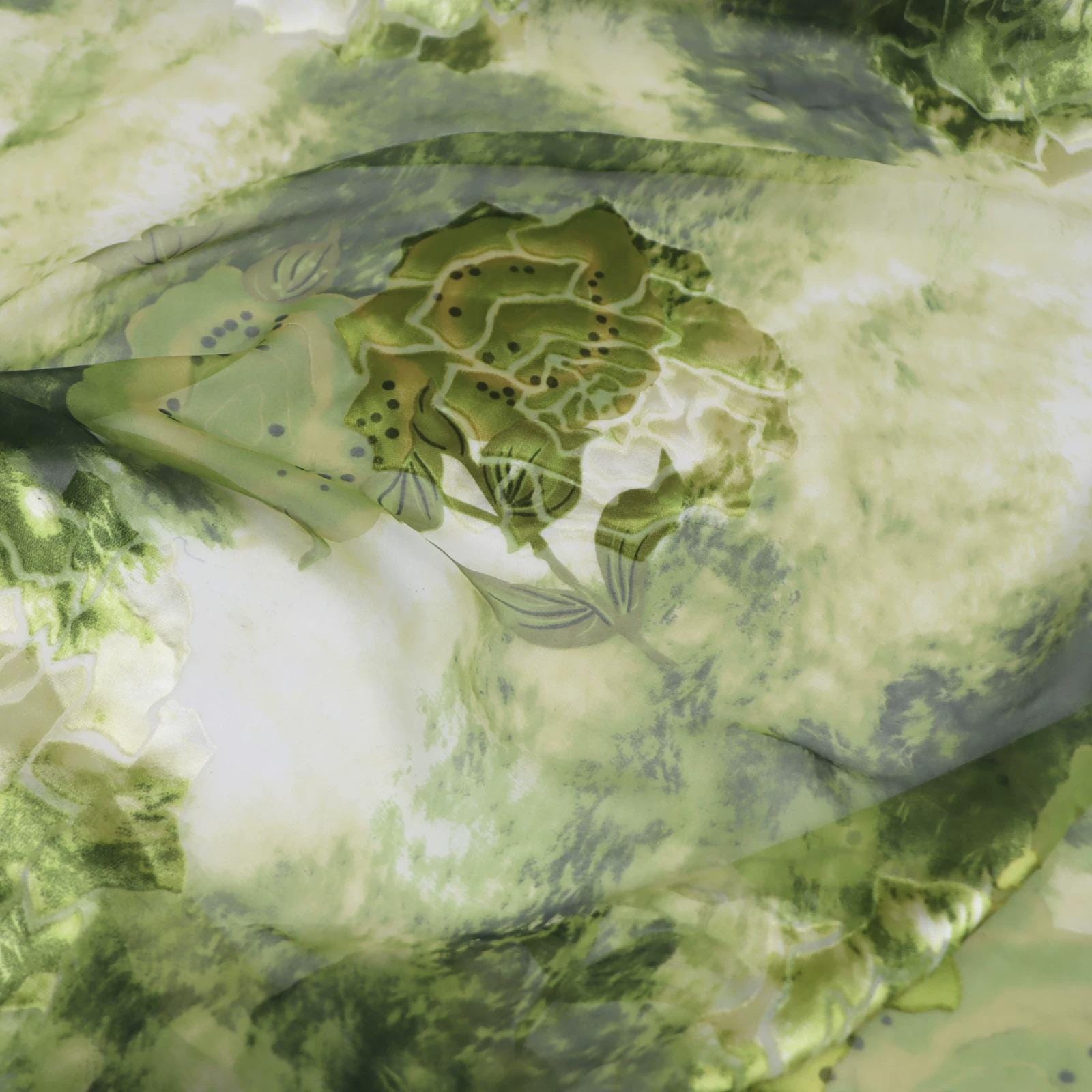 The image is a close-up of a fabric with a green and white floral pattern.