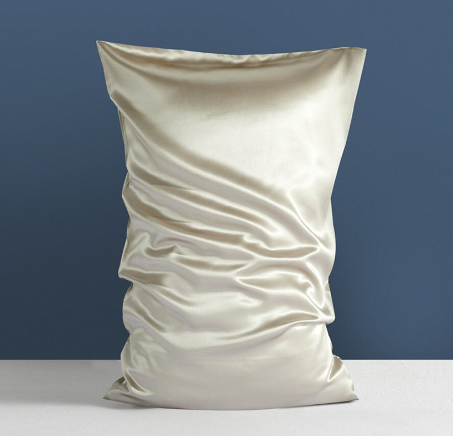 a white pillow sitting on top of a white table