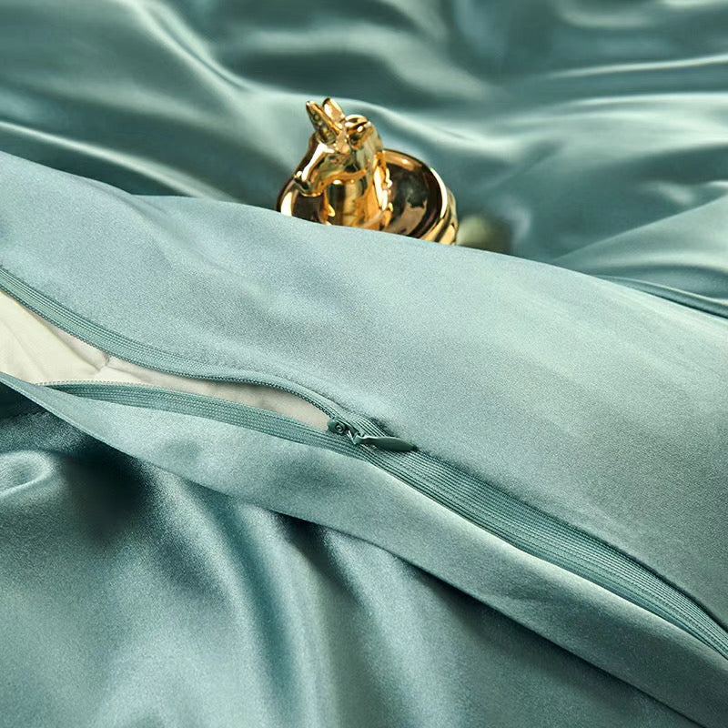 a close up of a bed with a green comforter