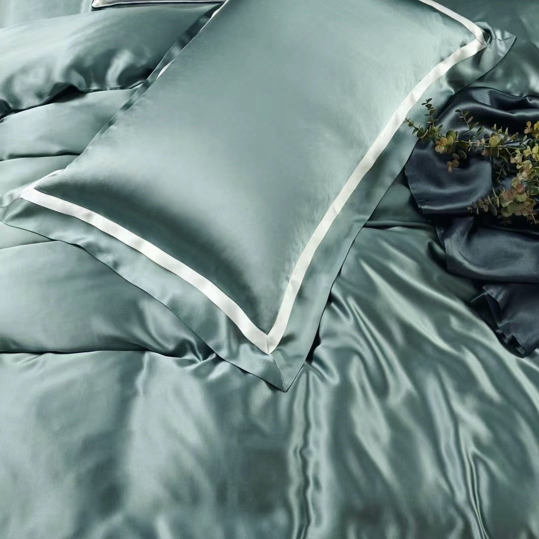 a close up of a bed with a green comforter