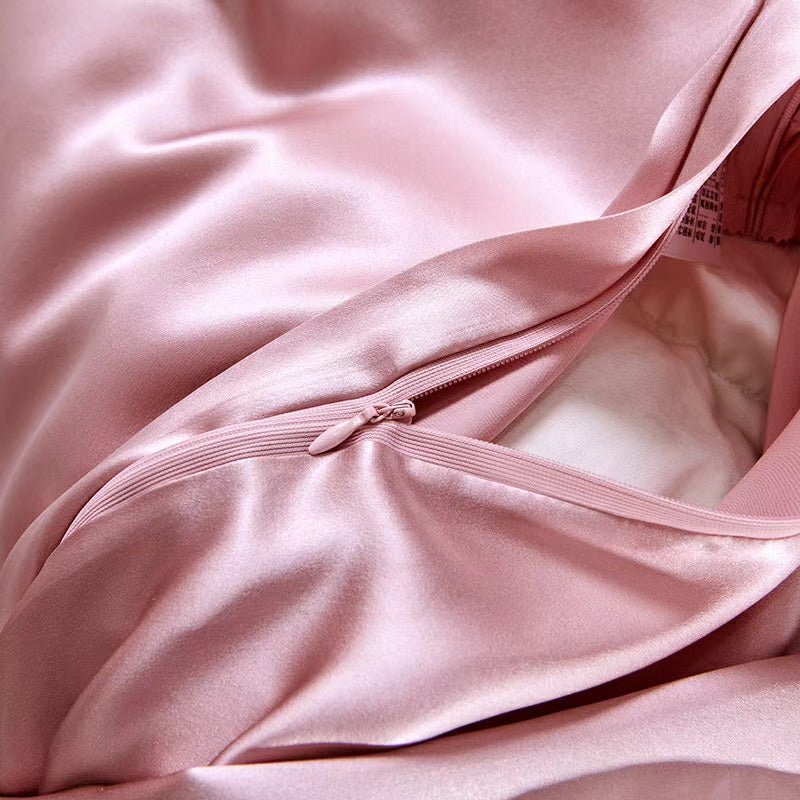 a close up of a pink satin material