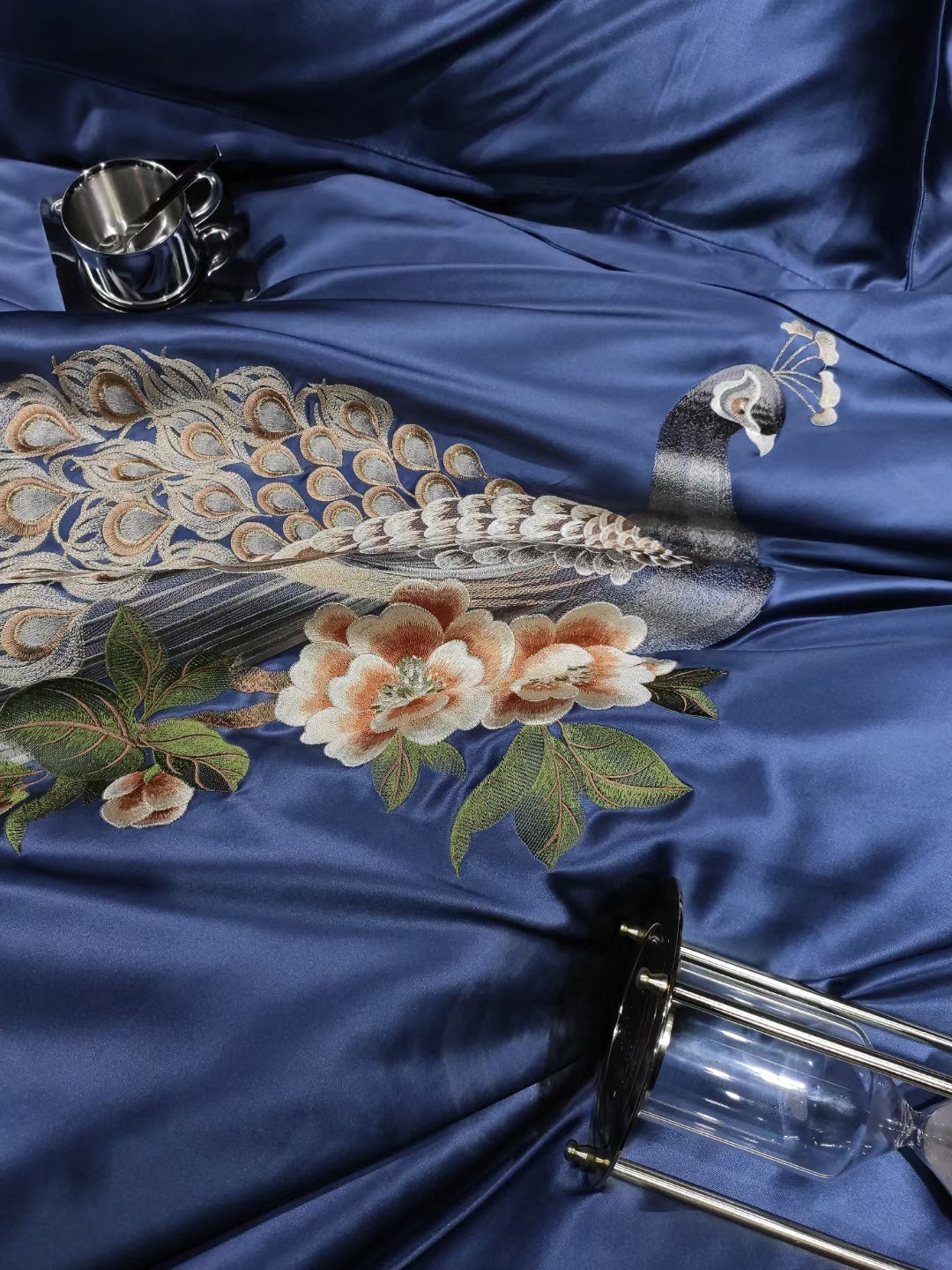 a peacock is laying on a blue satin sheet