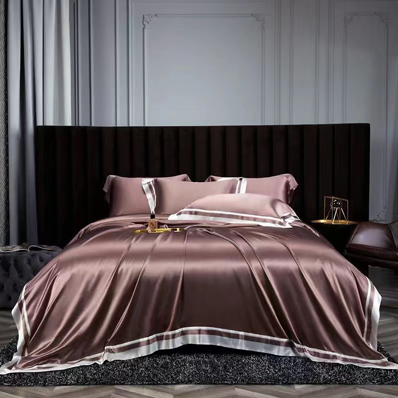 a bed with a pink comforter and pillows